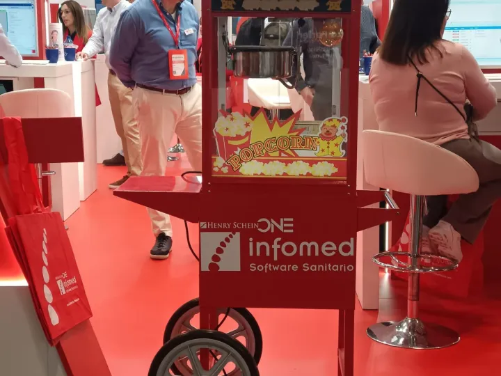Carrito de palomitas con logotipo de empresa en un stand de feria