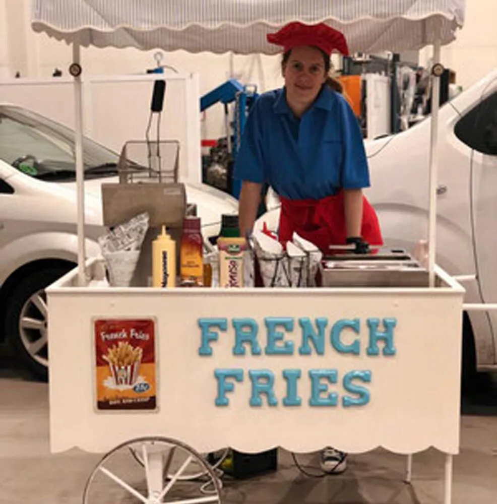 White fries cart with French Fries lettering and paper cones ready